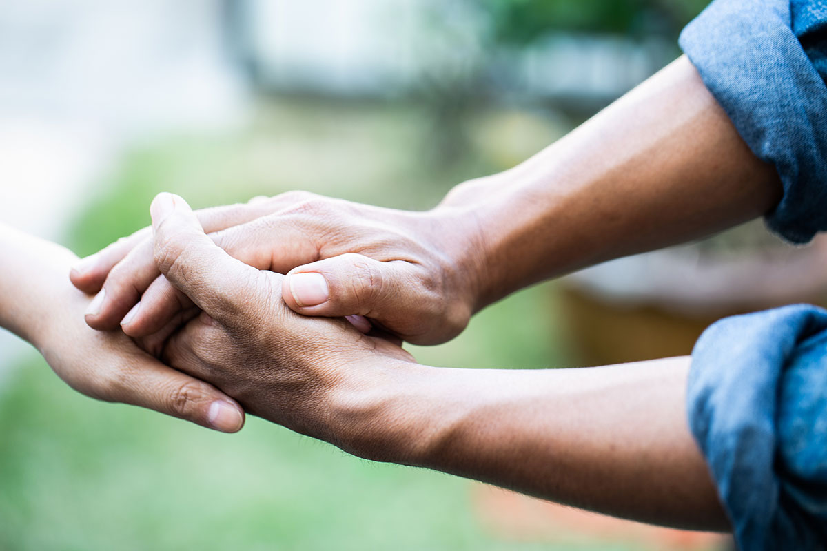 man holding persons hand